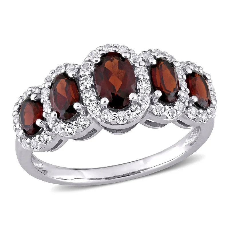 Rings with engraved constellations for stargazers -Miadora 10k White Gold Oval-cut Garnet and White Topaz 5-Stone Halo Ring